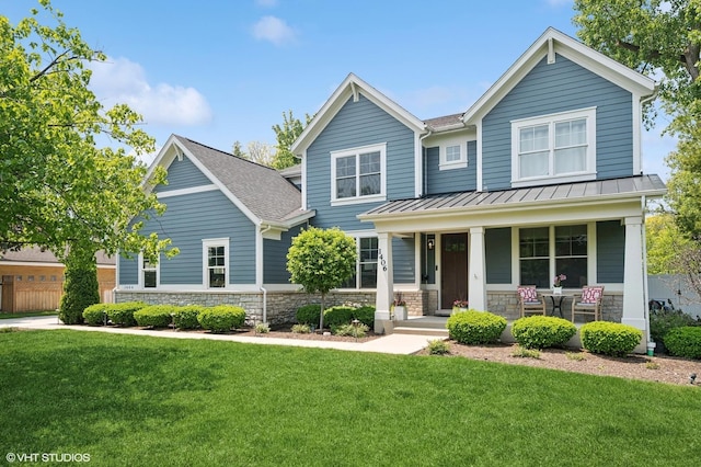 1406 Meadow Ln, Glenview, IL 60025 - craftsman house featuring covered porch, a front lawn, a standing seam roof, stone siding, and a metal roof