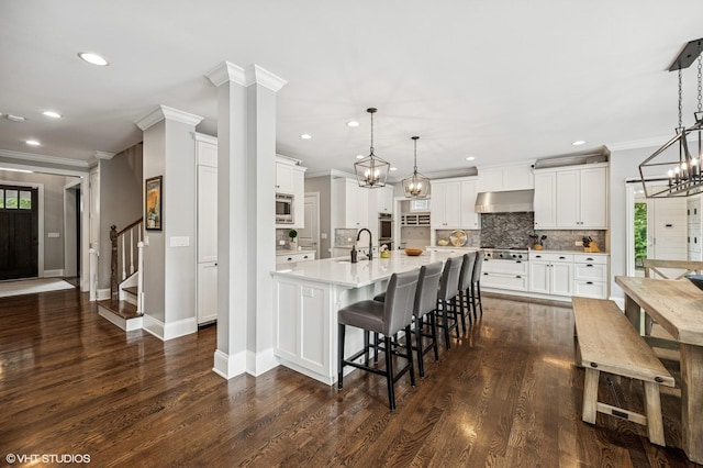 1406 Meadow Ln, Glenview, IL 60025 - kitchen with exhaust hood, appliances with stainless steel finishes, crown molding, light countertops, and tasteful backsplash