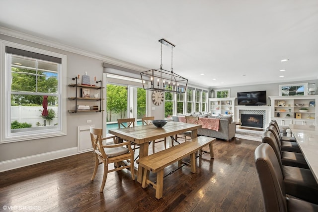 1406 Meadow Ln, Glenview, IL 60025 - dining space featuring plenty of natural light, crown molding, dark wood-style flooring, a tile fireplace, and recessed lighting