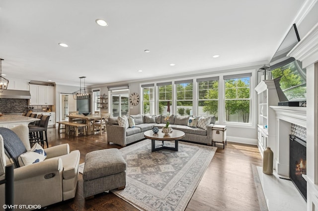 1406 Meadow Ln, Glenview, IL 60025 - living area featuring ornamental molding, a fireplace, a chandelier, recessed lighting, and wood finished floors