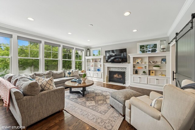 1406 Meadow Ln, Glenview, IL 60025 - living room with a barn door, crown molding, recessed lighting, a tile fireplace, and dark wood-style flooring