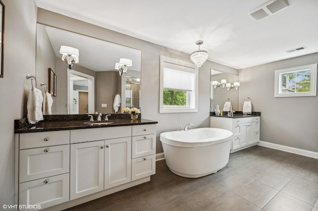 1406 Meadow Ln, Glenview, IL 60025 - bathroom featuring two vanities, a freestanding bath, a chandelier, and tile patterned flooring