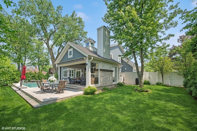 1406 Meadow Ln, Glenview, IL 60025 - back of house with stone siding, a fenced backyard, a patio, and a chimney
