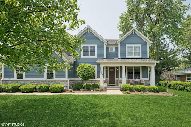 1406 Meadow Ln, Glenview, IL 60025 - view of front of house with stone siding, a porch, a standing seam roof, and a front lawn