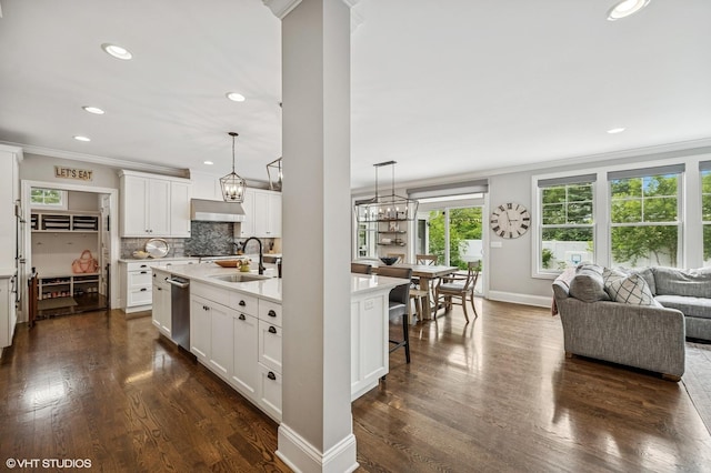 1406 Meadow Ln, Glenview, IL 60025 - kitchen with under cabinet range hood, crown molding, dark wood-type flooring, open floor plan, and a kitchen island with sink