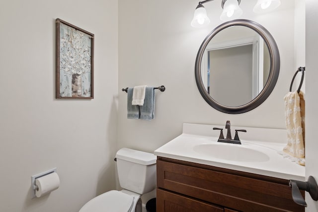bathroom featuring toilet and vanity