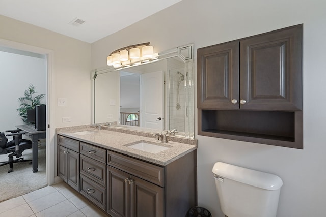 bathroom featuring double vanity, tile patterned floors, and a tile shower