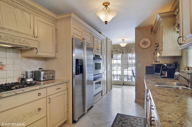 1858 Habberton Ave, Park Ridge, IL 60068 - kitchen with cream cabinets, appliances with stainless steel finishes, tasteful backsplash, light tile patterned floors, and light stone counters