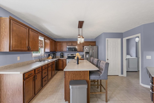 3905 Boulder Ridge Dr, Champaign, IL 61822 - kitchen with stainless steel appliances, a kitchen bar, light countertops, and light tile patterned floors