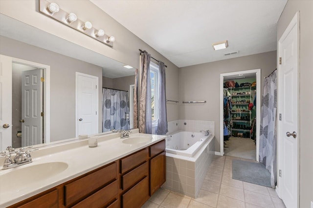 3905 Boulder Ridge Dr, Champaign, IL 61822 - full bathroom with a tub with jets, tile patterned flooring, double vanity, and a spacious closet