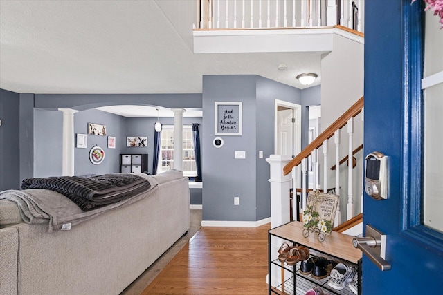 3905 Boulder Ridge Dr, Champaign, IL 61822 - living area with decorative columns, arched walkways, wood finished floors, and stairway