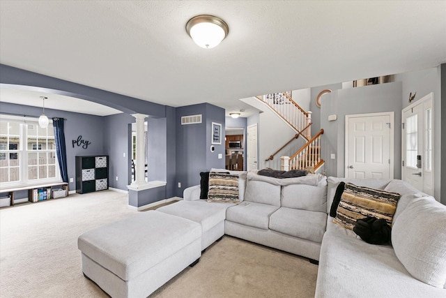 3905 Boulder Ridge Dr, Champaign, IL 61822 - living area featuring ornate columns, light colored carpet, stairway, and arched walkways