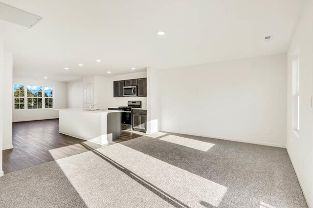877 Briar Glen Ct, Hampshire, IL 60140 - kitchen featuring appliances with stainless steel finishes, open floor plan, a center island with sink, recessed lighting, and light countertops