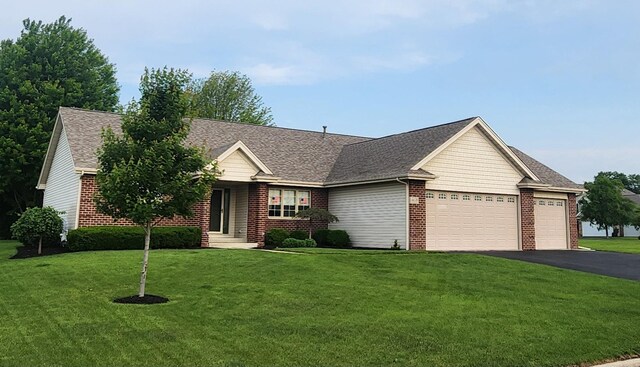 6638 Key Largo Dr, Machesney Park, IL 61103 - single story home featuring a garage, brick siding, driveway, and a front yard