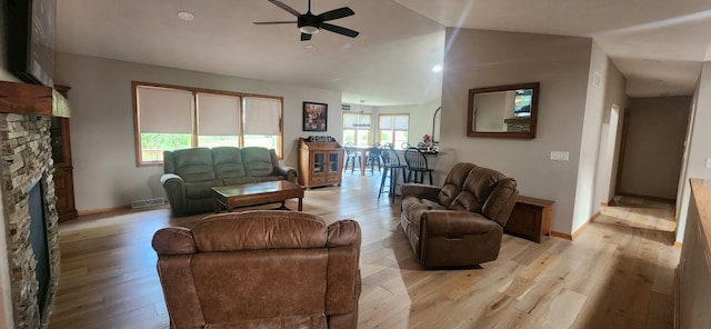 6638 Key Largo Dr, Machesney Park, IL 61103 - living room featuring a ceiling fan, light wood-type flooring, a fireplace, and vaulted ceiling