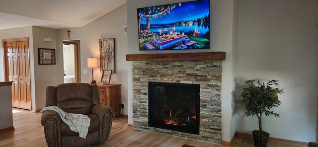 6638 Key Largo Dr, Machesney Park, IL 61103 - sitting room with a fireplace, vaulted ceiling, wood finished floors, and baseboards
