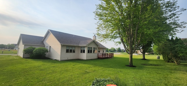 6638 Key Largo Dr, Machesney Park, IL 61103 - view of side of property featuring a chimney, a yard, and a wooden deck