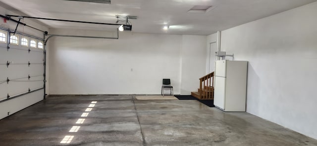 6638 Key Largo Dr, Machesney Park, IL 61103 - garage with freestanding refrigerator and a garage door opener