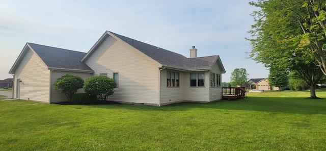 6638 Key Largo Dr, Machesney Park, IL 61103 - view of property exterior featuring a yard, a chimney, a wooden deck, and roof with shingles