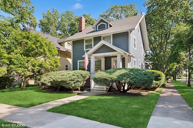 1241 Forest Ave, Wilmette, IL 60091 - traditional style home featuring a chimney, a front lawn, roof with shingles, and covered porch
