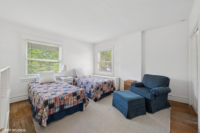 1241 Forest Ave, Wilmette, IL 60091 - bedroom with multiple windows, wood finished floors, and a closet