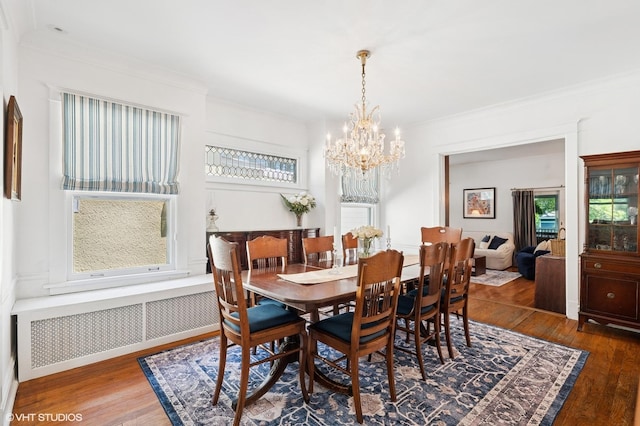 1241 Forest Ave, Wilmette, IL 60091 - dining room with radiator heating unit, a chandelier, wood finished floors, and crown molding