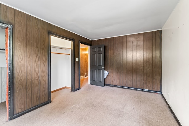 14217 Turner Ave, Robbins, IL 60472 - unfurnished bedroom featuring carpet flooring, wooden walls, baseboards, and a closet