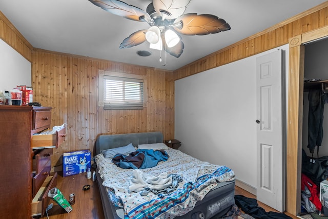 14217 Turner Ave, Robbins, IL 60472 - bedroom featuring wooden walls, wood finished floors, crown molding, and ceiling fan