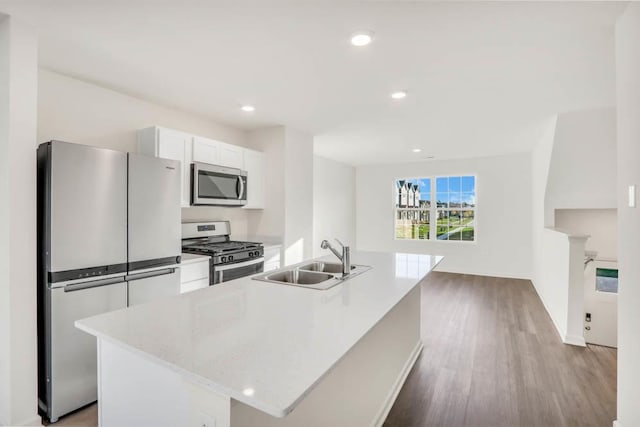 879 Briar Glen Ct, Hampshire, IL 60140 - kitchen featuring stainless steel appliances, light countertops, white cabinets, wood finished floors, and a kitchen island with sink