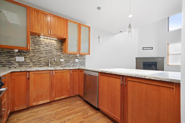 1550 N Leavitt St Unit 1550, Chicago, IL 60622 - kitchen featuring stainless steel dishwasher, light wood-style flooring, decorative backsplash, hanging light fixtures, and light stone countertops