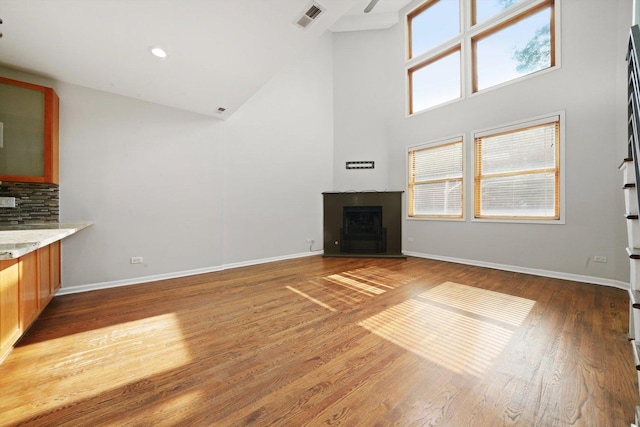 1550 N Leavitt St Unit 1550, Chicago, IL 60622 - unfurnished living room featuring high vaulted ceiling, a stone fireplace, and wood finished floors