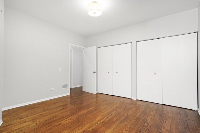 1550 N Leavitt St Unit 1550, Chicago, IL 60622 - unfurnished bedroom with two closets and wood finished floors