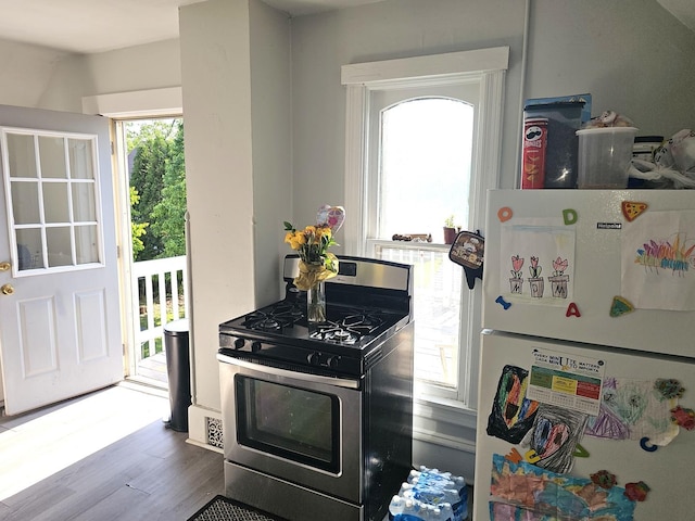 310 Hill Ave, Elgin, IL 60120 - kitchen featuring freestanding refrigerator, stainless steel gas range oven, and wood finished floors