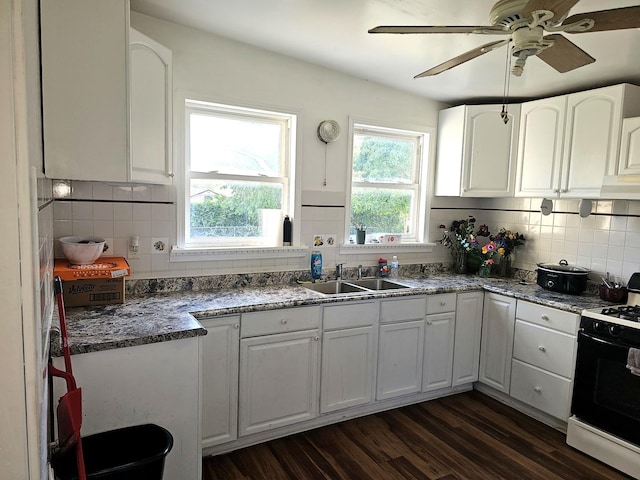 310 Hill Ave, Elgin, IL 60120 - kitchen with range with gas stovetop, decorative backsplash, dark wood-style flooring, white cabinetry, and ceiling fan