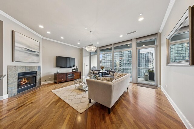 333 N Canal St Unit 2505, Chicago, IL 60606 - living area with crown molding, wood finished floors, recessed lighting, and a tiled fireplace
