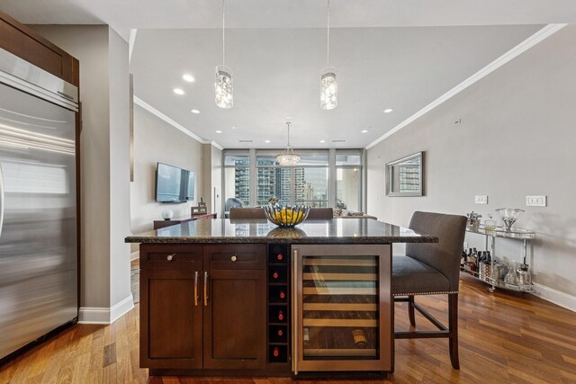 333 N Canal St Unit 2505, Chicago, IL 60606 - bar featuring built in fridge, beverage cooler, crown molding, dark wood-style floors, and pendant lighting