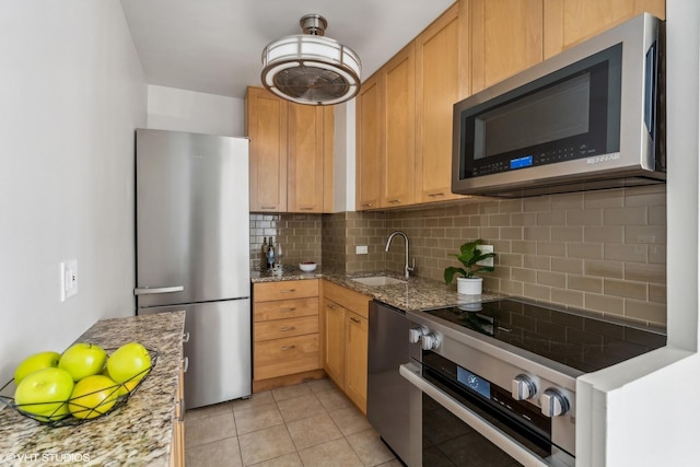 880 N Lake Shore Dr Unit 4E, Chicago, IL 60611 - kitchen with stainless steel appliances, decorative backsplash, light stone countertops, and light tile patterned floors