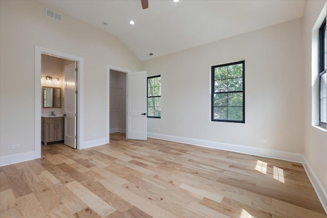 223 Center St, Naperville, IL 60540 - unfurnished bedroom featuring a spacious closet, light wood-type flooring, vaulted ceiling, baseboards, and recessed lighting