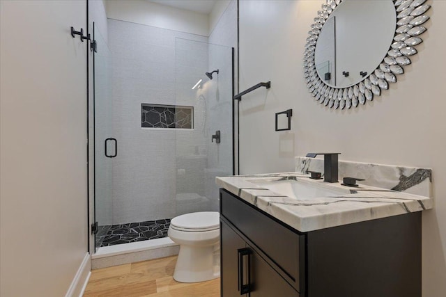 223 Center St, Naperville, IL 60540 - bathroom with toilet, a stall shower, wood finished floors, vanity, and baseboards