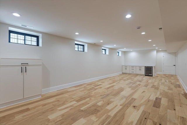 223 Center St, Naperville, IL 60540 - below grade area with beverage cooler, recessed lighting, light wood finished floors, and baseboards