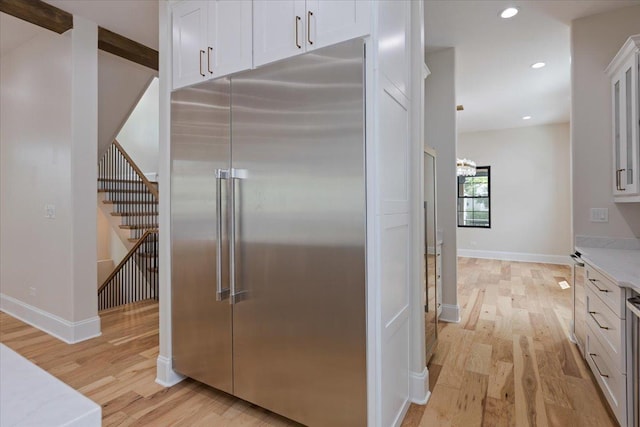 223 Center St, Naperville, IL 60540 - kitchen featuring stainless steel built in fridge, light wood-style flooring, white cabinets, and recessed lighting