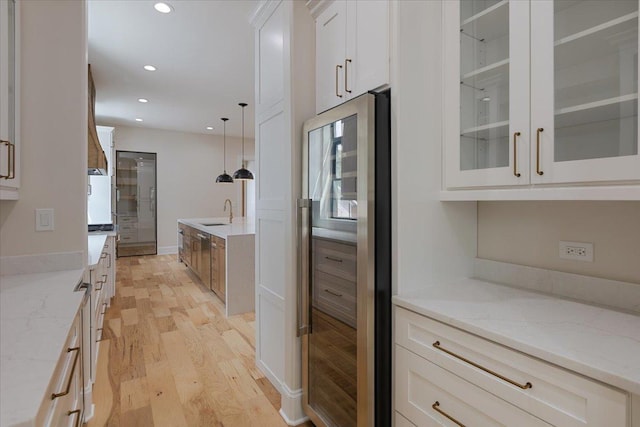 223 Center St, Naperville, IL 60540 - kitchen with light wood finished floors, beverage cooler, glass insert cabinets, white cabinetry, and recessed lighting