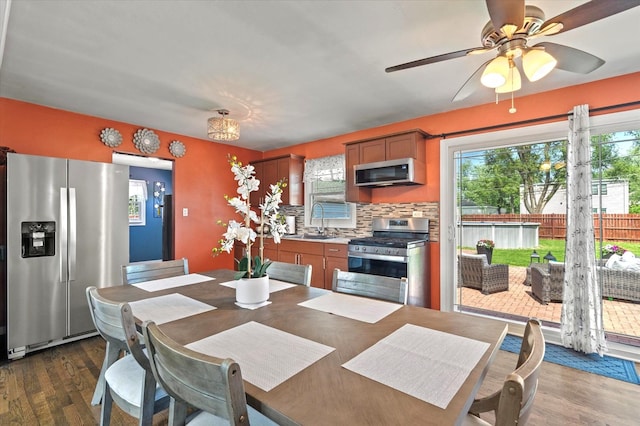 7937 S Lotus Ave, Burbank, IL 60459 - kitchen with stainless steel appliances, dark wood-style flooring, a sink, decorative backsplash, and ceiling fan