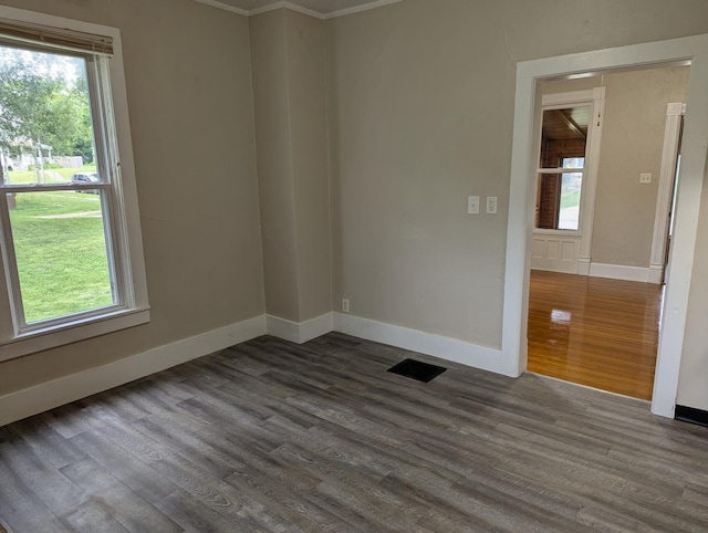 314 W Chestnut, Freeport, IL 61032 - unfurnished room with dark wood-type flooring, healthy amount of natural light, baseboards, and ornamental molding
