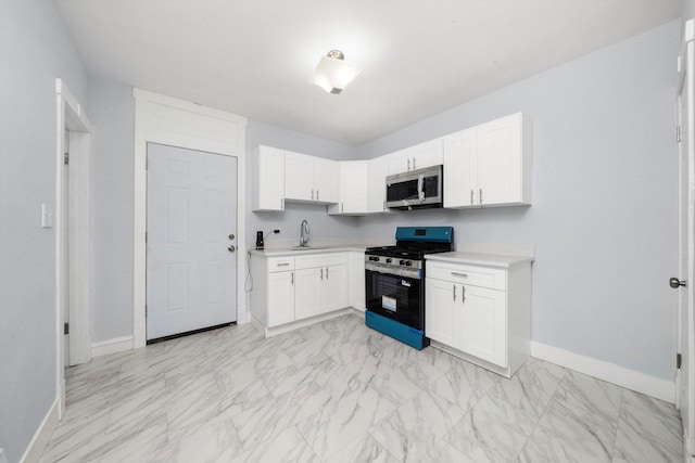 6742 S Honore St, Chicago, IL 60636 - kitchen with stainless steel appliances, light countertops, white cabinetry, and light marble finish floors