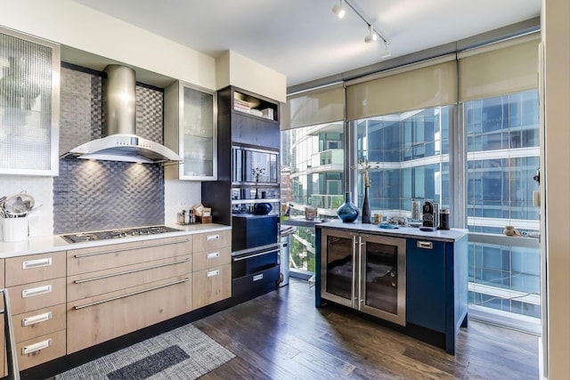 1211 S Prairie Ave Unit 1106, Chicago, IL 60605 - kitchen with wall chimney range hood, black oven, dark wood-type flooring, backsplash, and light countertops