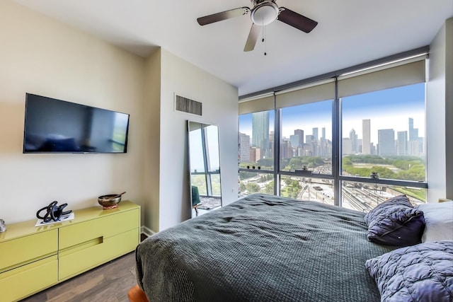 1211 S Prairie Ave Unit 1106, Chicago, IL 60605 - bedroom with a view of skyline, wood finished floors, floor to ceiling windows, and a ceiling fan