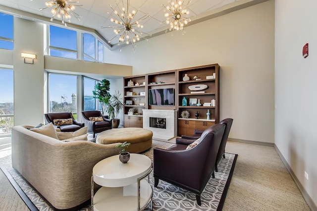 1211 S Prairie Ave Unit 1106, Chicago, IL 60605 - living area with a chandelier, a towering ceiling, a glass covered fireplace, and light carpet