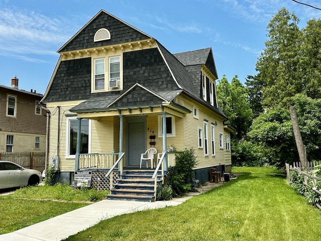 478 Barrett St, Elgin, IL 60120 - victorian home featuring a porch, a shingled roof, and cooling unit