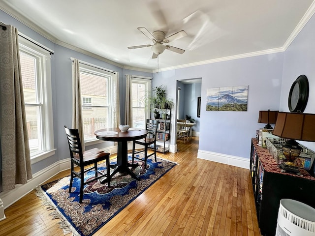 478 Barrett St, Elgin, IL 60120 - dining room featuring hardwood / wood-style flooring, a ceiling fan, baseboards, and crown molding